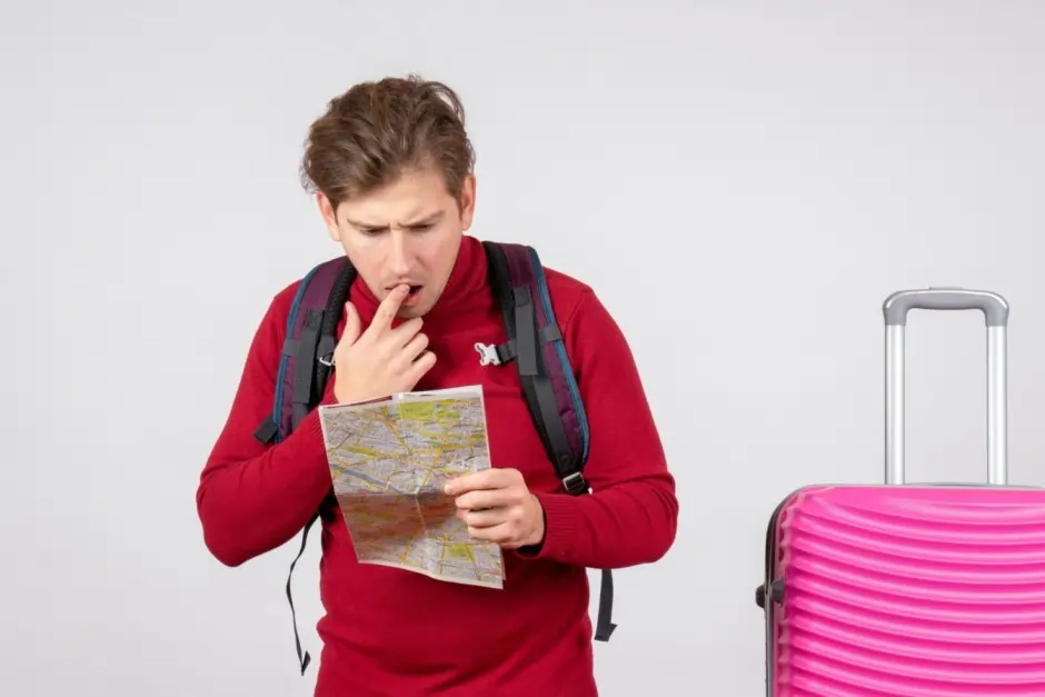 Stressed tourist looking at a map, showing the emotional patterns and signs associated with travel fever before a trip.
