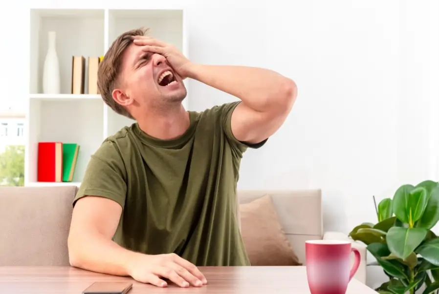 Anxiety When persistent restlessness and nervousness overwhelm you man clutching head in stress, showing anxiety at home